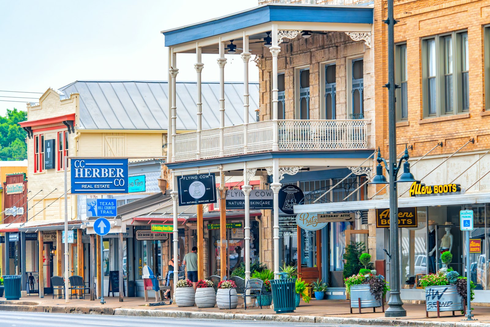 A charming small-town main street lined with local storefronts in warm daylight